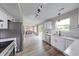 Open-concept kitchen with stainless steel appliances, an island, and an adjacent dining area at 705 Treyburn Lakes Way, Indianapolis, IN 46239