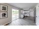 Bright and modern kitchen, featuring white cabinetry, stainless appliances, hardwood floors, and access to a deck at 705 Treyburn Lakes Way, Indianapolis, IN 46239