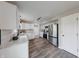 Well-lit kitchen featuring white cabinets, stainless steel appliances, and sleek flooring, with modern lighting fixtures at 705 Treyburn Lakes Way, Indianapolis, IN 46239