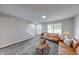 Cozy living room featuring neutral walls, stylish decor, and hardwood floors; a staircase is visible to the side at 705 Treyburn Lakes Way, Indianapolis, IN 46239