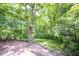Expansive backyard featuring a brick patio and lush greenery offering privacy and serene outdoor living at 7115 Fremont Ct, Indianapolis, IN 46256