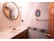 Well-maintained bathroom features a vanity, ornate mirror, and patterned wallpaper at 7115 Fremont Ct, Indianapolis, IN 46256