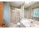 Clean bathroom featuring a shower with sliding glass doors, a vanity, and fresh green paint at 7115 Fremont Ct, Indianapolis, IN 46256