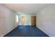 Bedroom featuring a blue carpet, patterned wallpaper, and two closet doors at 7115 Fremont Ct, Indianapolis, IN 46256