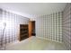 Bedroom featuring a neutral carpet, plaid wallpaper, and a closet door at 7115 Fremont Ct, Indianapolis, IN 46256