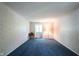 Bedroom featuring a blue carpet, patterned wallpaper, and a window with natural light at 7115 Fremont Ct, Indianapolis, IN 46256