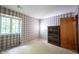 Bedroom featuring a neutral carpet, plaid wallpaper, and window with natural light at 7115 Fremont Ct, Indianapolis, IN 46256