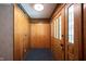 Functional entryway features wood paneling, a closet for storage, and a door with glass panels at 7115 Fremont Ct, Indianapolis, IN 46256