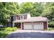 Charming brick home with a two-car garage and a well-manicured lawn surrounded by lush trees at 7115 Fremont Ct, Indianapolis, IN 46256