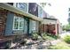 Charming brick home with covered front porch and blue shutters, framed by lush greenery at 7115 Fremont Ct, Indianapolis, IN 46256