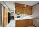 Charming kitchen featuring wood cabinetry, modern appliances and a functional layout at 7115 Fremont Ct, Indianapolis, IN 46256