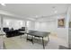 Finished basement features a ping pong table, entertainment area and comfortable seating at 7138 Nile Ridge Ct, Indianapolis, IN 46236