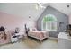 A cozy bedroom featuring natural light, sloped ceiling, and a comfortable area at 7138 Nile Ridge Ct, Indianapolis, IN 46236