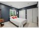 This bedroom includes carpeted floors, natural lighting, and a closet at 7138 Nile Ridge Ct, Indianapolis, IN 46236