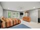 Bright bedroom features large windows, ceiling fan, TV, dresser, and carpeting, providing a comfortable and inviting space at 7138 Nile Ridge Ct, Indianapolis, IN 46236