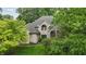 Charming, light brick home with lush greenery and mature trees, offering a serene and private setting at 7138 Nile Ridge Ct, Indianapolis, IN 46236