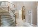 Elegant foyer showcasing a staircase, neutral tones, and archway, offering a warm and inviting welcome at 7138 Nile Ridge Ct, Indianapolis, IN 46236