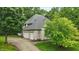 Detached three-car garage with white brick and attached driveway; surrounded by mature landscaping at 7138 Nile Ridge Ct, Indianapolis, IN 46236