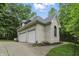 Detached three-car garage with white brick and attached driveway; surrounded by mature landscaping at 7138 Nile Ridge Ct, Indianapolis, IN 46236