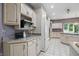 Spacious kitchen featuring white cabinets, a tiled floor, and stainless steel appliances at 7138 Nile Ridge Ct, Indianapolis, IN 46236