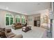 Bright living room featuring arched windows, neutral walls, carpet, and a fireplace at 7138 Nile Ridge Ct, Indianapolis, IN 46236