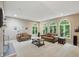 Spacious living room featuring neutral walls, carpet, and arched windows with a view of the outside at 7138 Nile Ridge Ct, Indianapolis, IN 46236