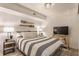 Stylish bedroom with a patterned bedspread, TV, and decorative oars at 7207 Grouper Dr, Nineveh, IN 46164