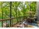 Beautiful deck with wooded view, a wooden table and chairs, and outdoor umbrella at 7207 Grouper Dr, Nineveh, IN 46164
