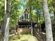 A-frame home with a wraparound deck surrounded by beautiful trees and lush foliage at 7207 Grouper Dr, Nineveh, IN 46164