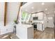 Bright kitchen boasts white cabinets, countertops, stainless appliances, and peninsula bar at 7207 Grouper Dr, Nineveh, IN 46164
