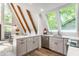 This open concept kitchen features white cabinets and countertops, with vaulted ceilings at 7207 Grouper Dr, Nineveh, IN 46164