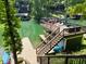 Lakeside deck with outdoor furniture and stairs to the dock and lake at 7207 Grouper Dr, Nineveh, IN 46164