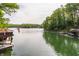 Expansive lake view with a boat house and dock in a wooded area at 7207 Grouper Dr, Nineveh, IN 46164