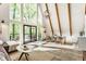 Bright living room with wooden beams, dining area and large windows with sliding doors to a deck at 7207 Grouper Dr, Nineveh, IN 46164