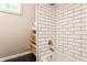 Bright bathroom shower with white subway tiles and black hexagon floors at 7207 Grouper Dr, Nineveh, IN 46164