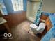 This bathroom with blue walls features a shower over tub and a classic toilet at 721 Haugh St, Indianapolis, IN 46222