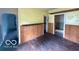 The dining room features hardwood floors, and wood wall trim, offering space for meals and gatherings at 721 Haugh St, Indianapolis, IN 46222