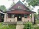 Charming two-story home featuring a covered front porch with brick pillars and a classic design at 721 Haugh St, Indianapolis, IN 46222