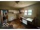 The kitchen has plenty of potential with white cabinets and space for updates at 721 Haugh St, Indianapolis, IN 46222
