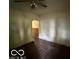 The living room boasts dark hardwood floors, vintage ceiling fan, and an arched doorway to the next room at 721 Haugh St, Indianapolis, IN 46222