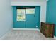 This turquoise bedroom features an exterior view and a wooden cabinet at 7529 Oceanline Dr, Indianapolis, IN 46214
