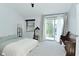 Bright bedroom with a sliding glass door and a bench at 7529 Oceanline Dr, Indianapolis, IN 46214