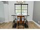Dining space showcases a modern table setup with a view through a large window with natural light at 7529 Oceanline Dr, Indianapolis, IN 46214