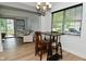 Open-concept dining area flows to the living room, featuring a modern table and natural light at 7529 Oceanline Dr, Indianapolis, IN 46214