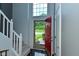 Inviting entryway with a peek outside, featuring stylish tile flooring and convenient coat closet at 7529 Oceanline Dr, Indianapolis, IN 46214