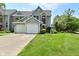 Charming two-story home features a two-car garage and well-manicured lawn and attractive curb appeal at 7529 Oceanline Dr, Indianapolis, IN 46214