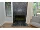 This living room boasts a black marble fireplace with an adjacent window at 7529 Oceanline Dr, Indianapolis, IN 46214