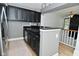 A well-appointed kitchen featuring dark cabinetry, modern countertops, stainless appliances, and wood-look flooring at 7529 Oceanline Dr, Indianapolis, IN 46214
