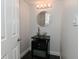Stylish powder room features a unique glass vessel sink, modern faucet, and decorative mirror at 7529 Oceanline Dr, Indianapolis, IN 46214