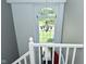 Bright stairwell featuring a large window and classic chandelier, offering a view of the outdoors at 7529 Oceanline Dr, Indianapolis, IN 46214